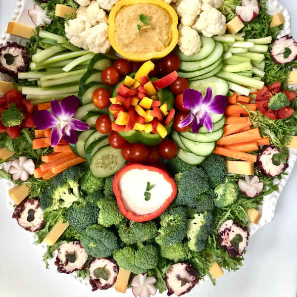 Vegetable platter arranged like a floral display on a white tray