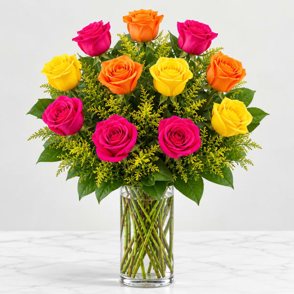 Bouquet of pink, orange, and yellow roses in a clear glass vase