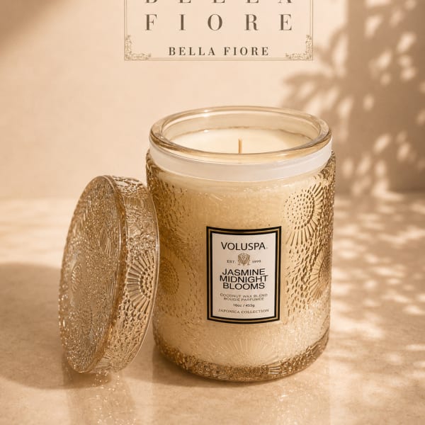 Decorative jasmine-scented candle in a glass jar with a patterned lid