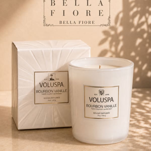 White scented candle with matching box on a beige surface