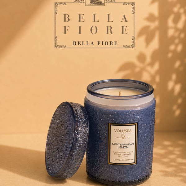 Blue scented candle in a decorative glass jar with lid