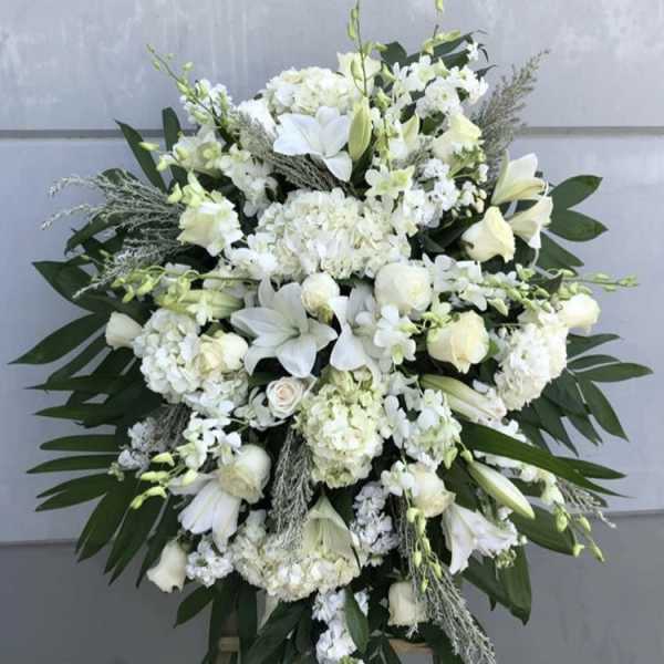 Large white floral standing spray on an easel