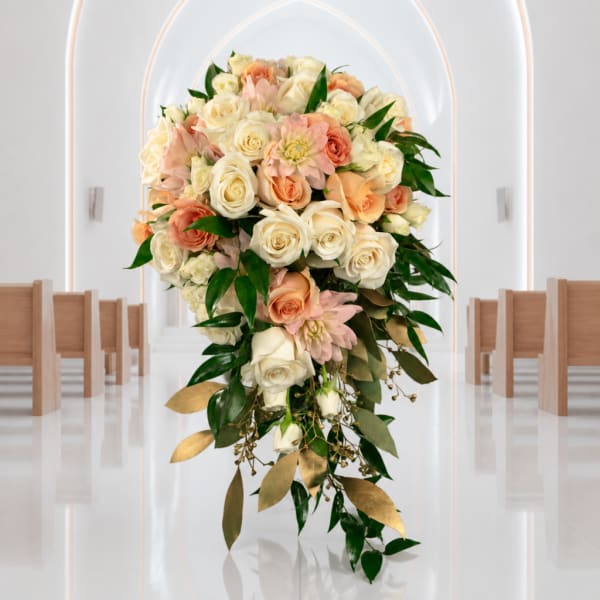 Cascade bouquet of cream and peach roses with pink flowers and greenery