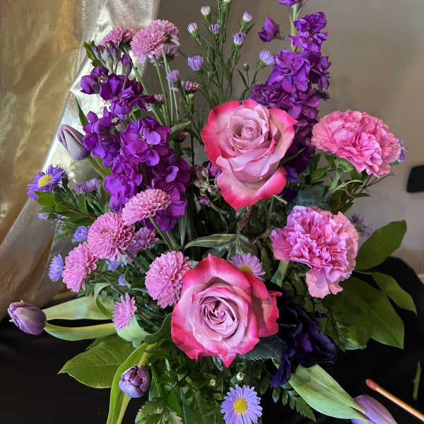 Bouquet of pink roses, purple flowers, and carnations