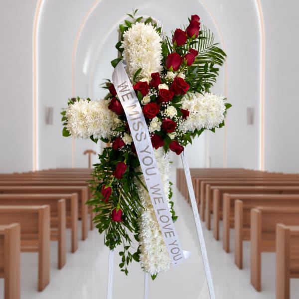 Standing funeral spray with red roses and white chrysanthemums on an easel