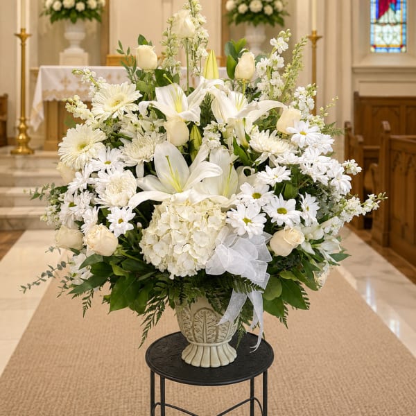 White floral arrangement in a vase inside a church