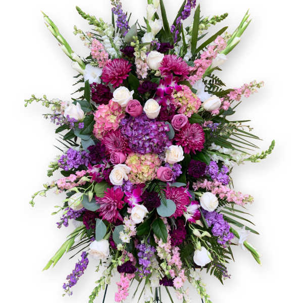 Large standing spray of pink, purple, and white flowers on an easel