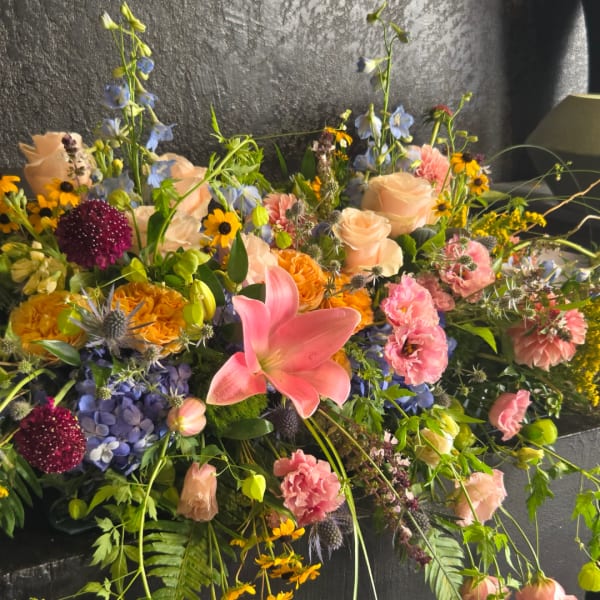 Large mixed bouquet with pink lilies, roses, and blue flowers