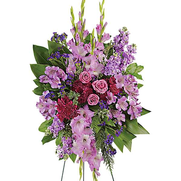 Standing spray of pink and purple flowers on a wire easel