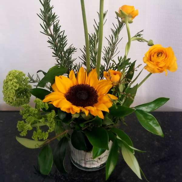 Mixed bouquet with red and yellow gerbera daisies in a glass vase