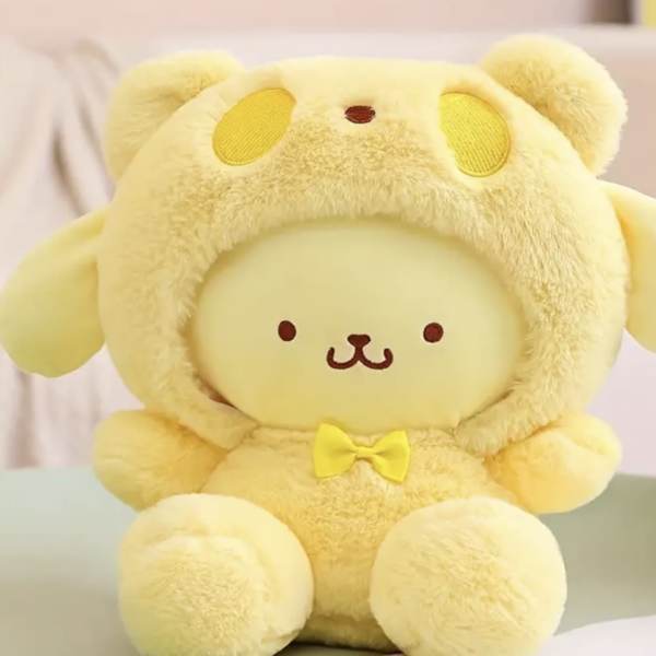 Yellow plush bear wearing a hood and bow tie