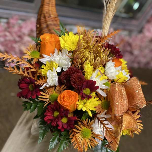 Bouquet of orange roses and mixed chrysanthemums with a ribbon bow
