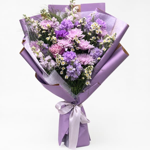 Lavender bouquet of mixed purple flowers wrapped in purple paper