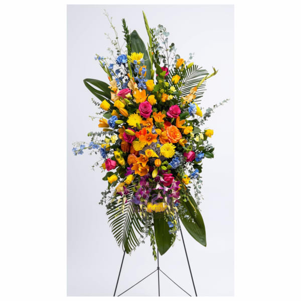 Tall standing spray of mixed colorful flowers on an easel