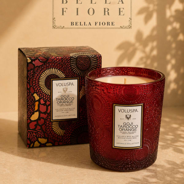 Red scented candle in a decorative glass jar with matching box