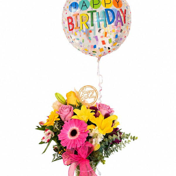 Birthday bouquet with a confetti balloon and pink ribbon in a glass vase