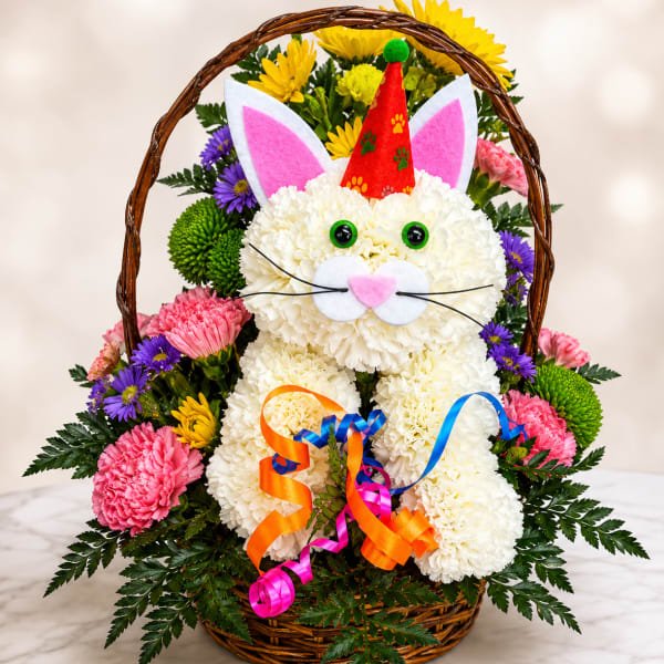 Basket arrangement shaped like a cat with colorful flowers and ribbons
