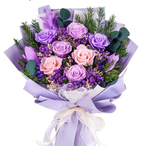 Bouquet of lavender and pink roses wrapped in purple paper