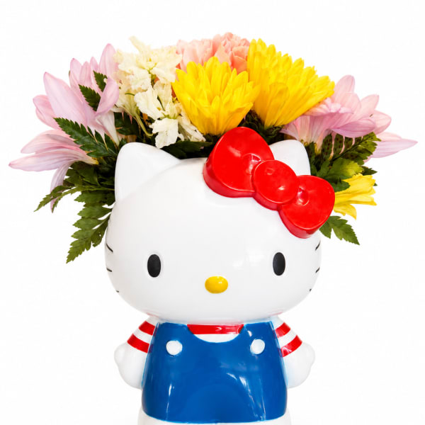 Hello Kitty planter filled with pink, yellow, and white flowers
