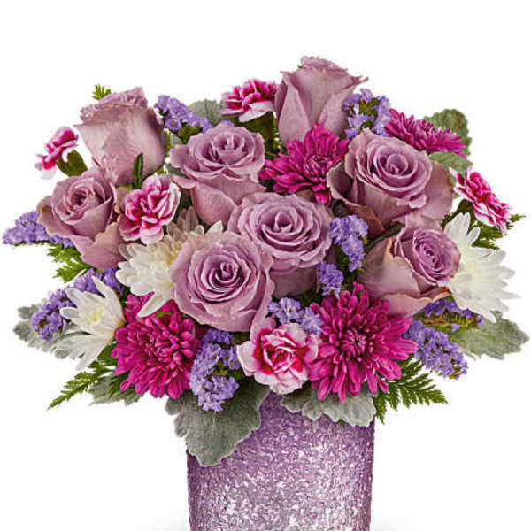 Lavender roses and pink daisies in a glittery purple vase