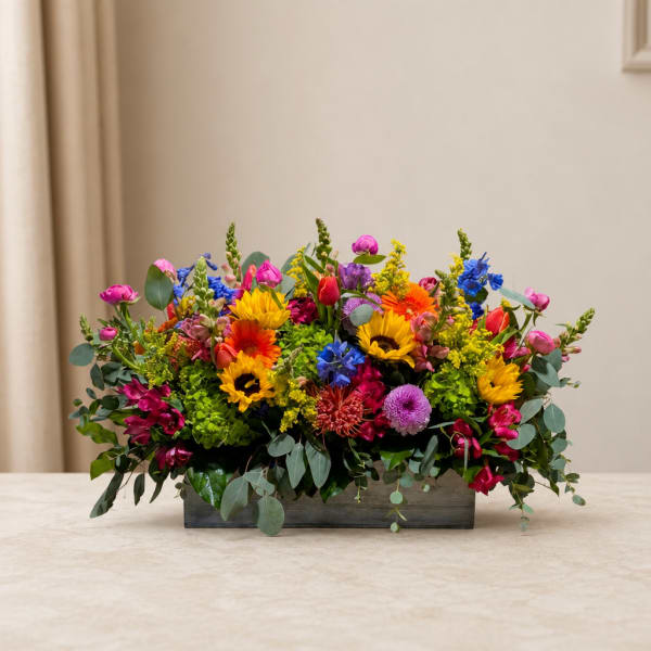 Colorful mixed flower arrangement in a rectangular wooden box