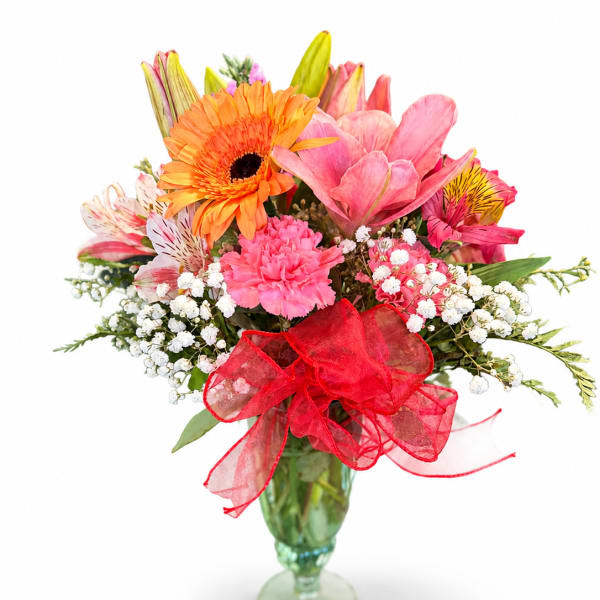 Mixed bouquet in a glass vase with a red ribbon