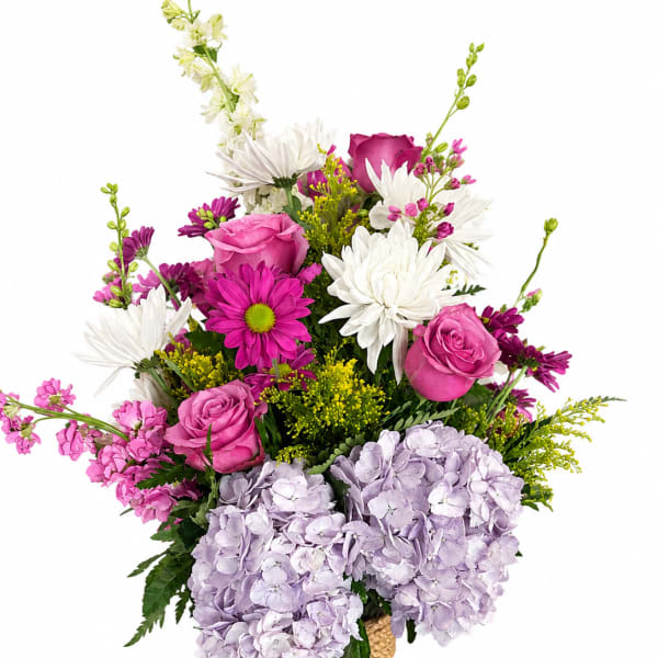 Pink and white mixed bouquet in a magenta glass vase