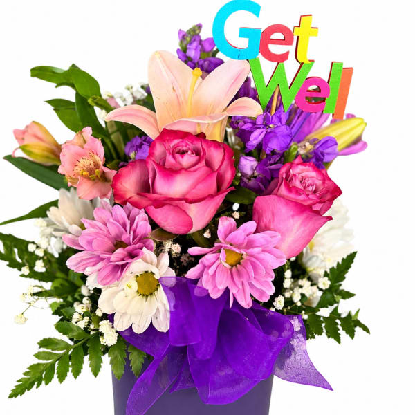Mixed bouquet in a purple vase with a colorful "Get Well" sign