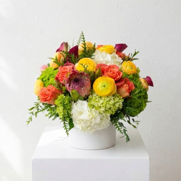 Colorful mixed bouquet in a white round box