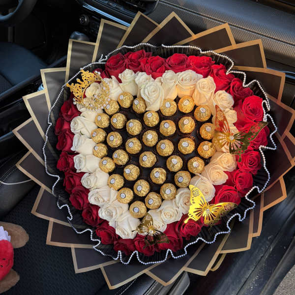 Heart-shaped bouquet of red and white roses with gold chocolates and butterfly accents