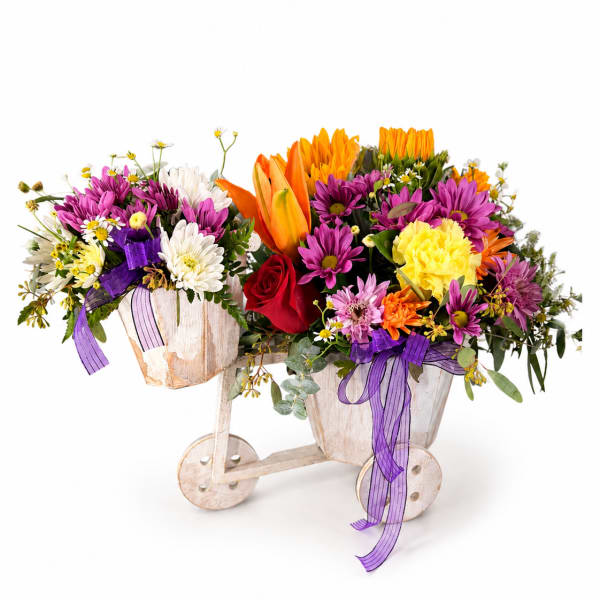 Two colorful flower arrangements in rustic wooden carts with purple ribbons