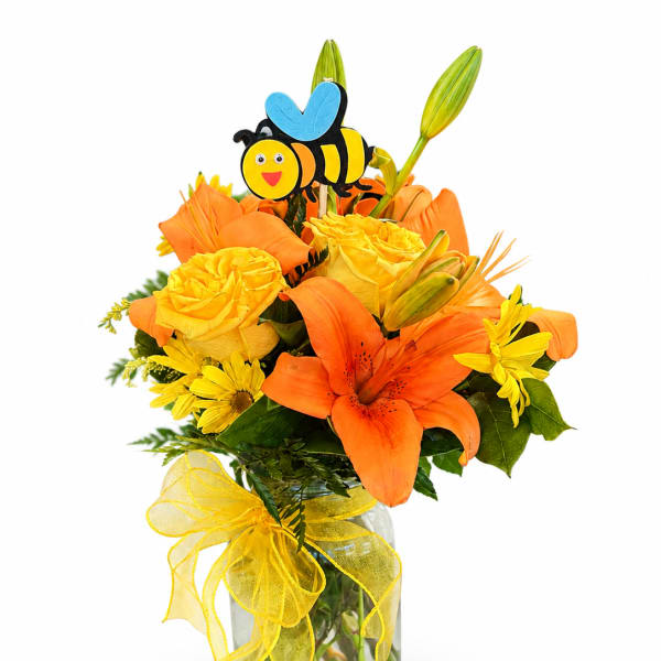 Orange and yellow bouquet in a glass vase with a bee decoration