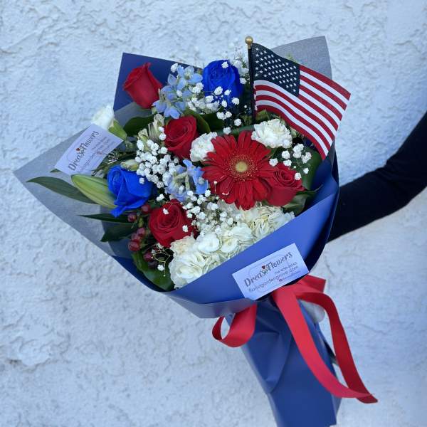 Bouquet of red, white, and blue flowers with an American flag