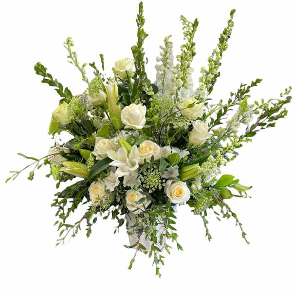 White roses and lilies in a tall, airy arrangement