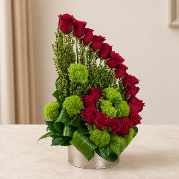 Red roses and green pom-pom flowers in a silver round container