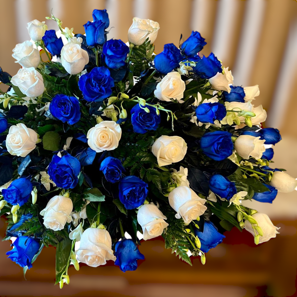 Bouquet of blue and white roses in a dense rounded arrangement