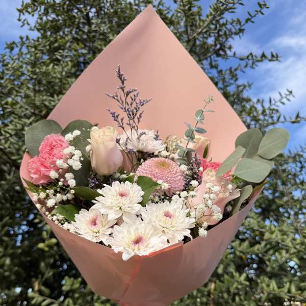 Pink and white bouquet wrapped in blush paper