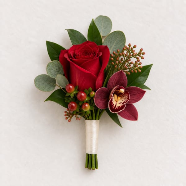 Red rose and burgundy orchid boutonniere with greenery