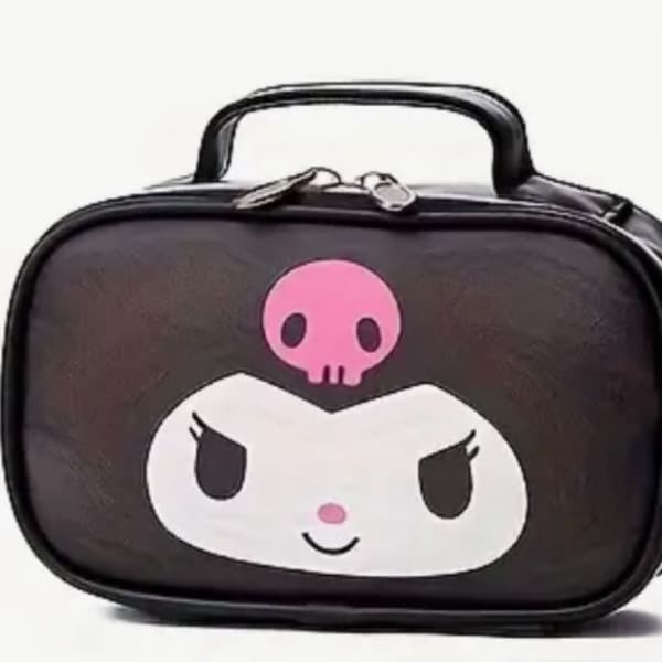 Black cosmetic bag with a cartoon face and pink skull graphic