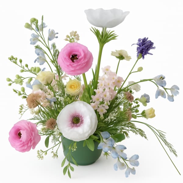 Mixed pastel flower arrangement in a green vase