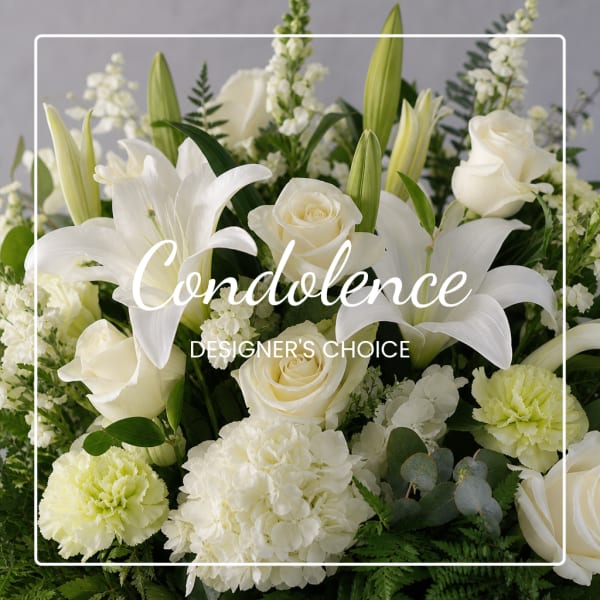 White lilies and roses arranged with pale green carnations and hydrangea