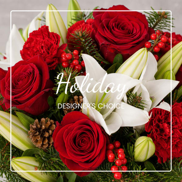 Red roses, white lilies, and red carnations in a holiday bouquet