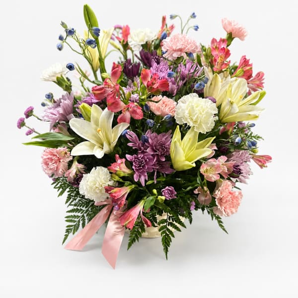 Mixed bouquet of lilies, carnations, and chrysanthemums in a vase