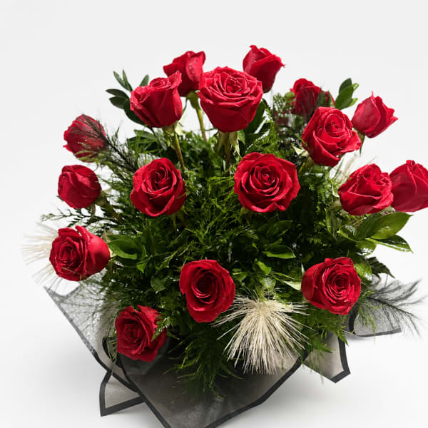 Bouquet of red roses with greenery and black wrap