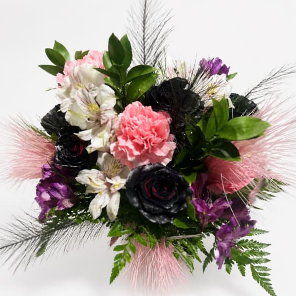 Bouquet of pink, white, purple, and black flowers with feathery accents
