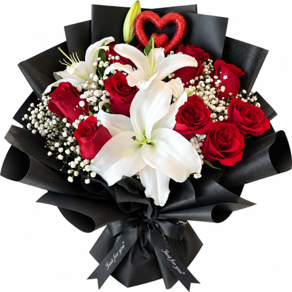 Bouquet of red roses and white lilies wrapped in black paper