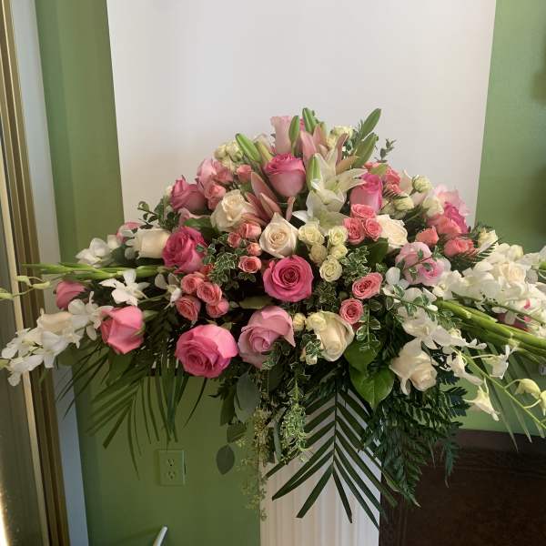 Large pink and white floral arrangement with roses and lilies