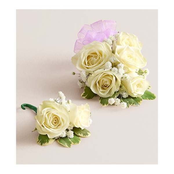 Two ivory rose corsages with small white filler flowers and purple ribbon