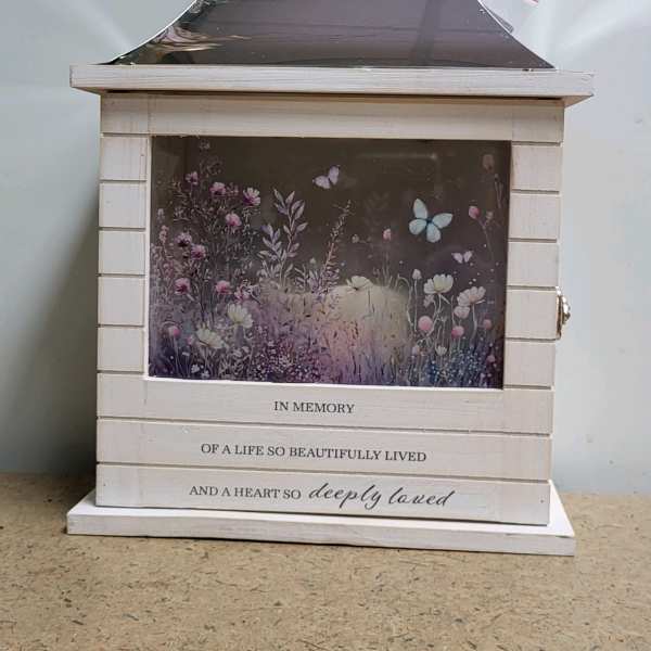 White memorial lantern with floral artwork and an engraved sympathy message