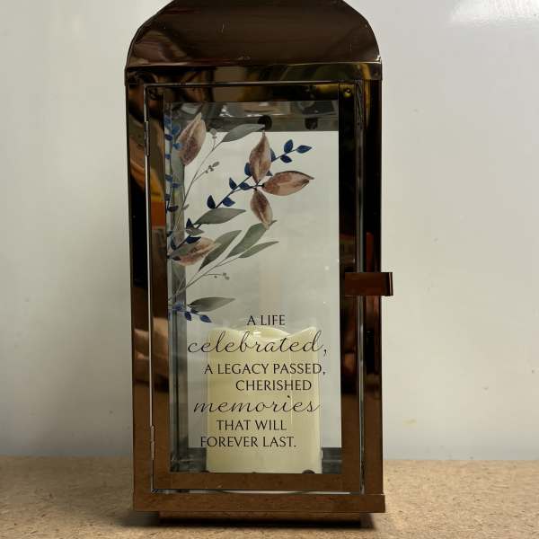 Bronze lantern with a memorial quote card inside